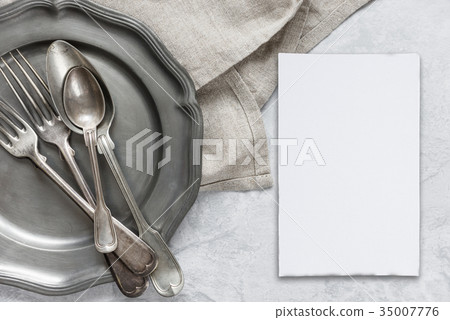 Silverware on a pewter plate 35007776