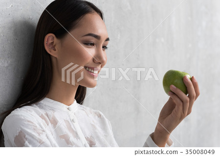 Outgoing female watching at green fruit Outgoing female watching at green fruit 35008049