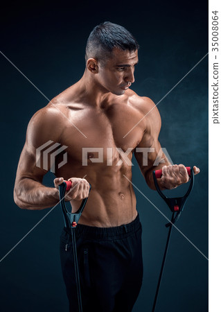 Fitness man exercising with stretching band Fitness man exercising with stretching band 35008064