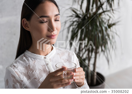 Smiling lady relaxing at work Smiling lady relaxing at work 35008202