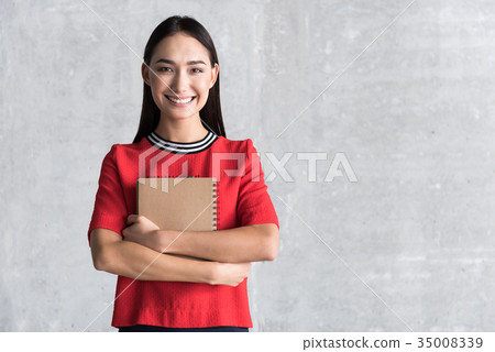 Hilarious smiling lady holding diary Hilarious smiling lady holding diary 35008339