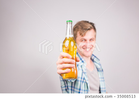 Handsome caucasian man holding a bottle of beer 35008513