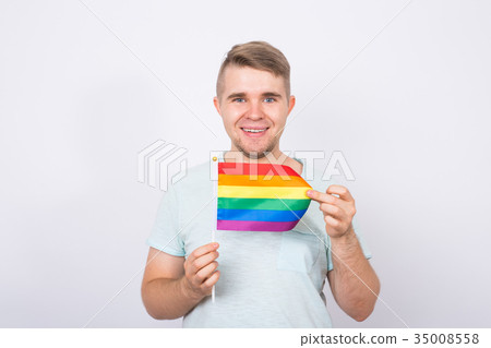 Young man hold a rainbow flag, gey boy. Concept of Young man hold a rainbow flag, gey boy. Concept of 35008558
