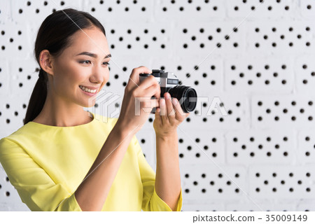 Elegant joyful young woman is enjoying her hobby 35009149