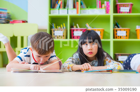 kid lay down on floor and reading tale book kid lay down on floor and reading tale book 35009190