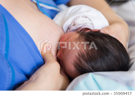 mother breast feeding to newborn baby mother breast feeding to newborn baby 35009457