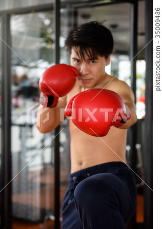 Man practicing Muay Thai at gym 35009486