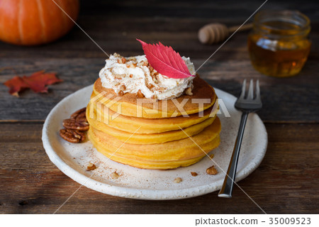 Pumpin pancakes with whipped cream and nuts 35009523