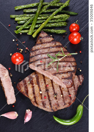 hot barbecued beef steaks with vegetables hot barbecued beef steaks with vegetables 35009846