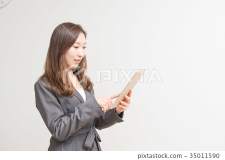 Career woman touching a tablet Career woman touching a tablet 35011590