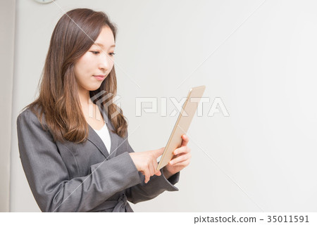Career woman touching a tablet 35011591