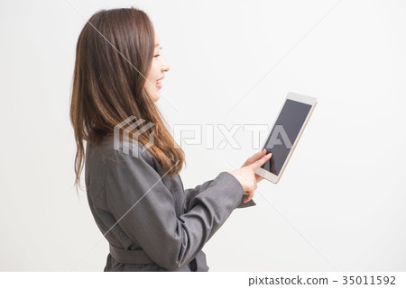 Career woman touching a tablet 35011592