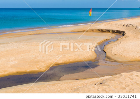 Sand beach pollution. Black water in creek on sand Sand beach pollution. Black water in creek on sand 35011741