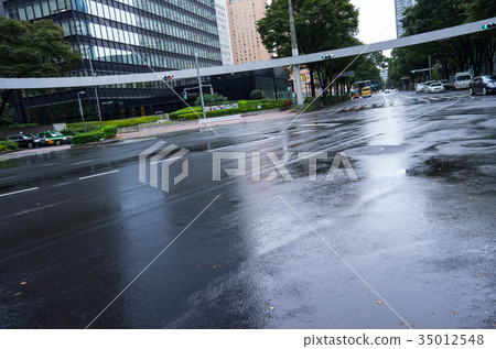 Rainy day intersection Tokyo wet road surface c 35012548