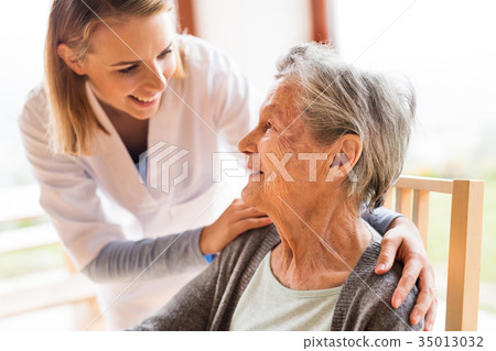 Health visitor and a senior woman during home 35013032
