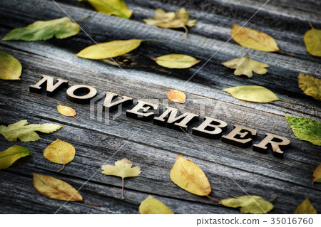 Word November, wooden letters. Yyellow leaves 35016760
