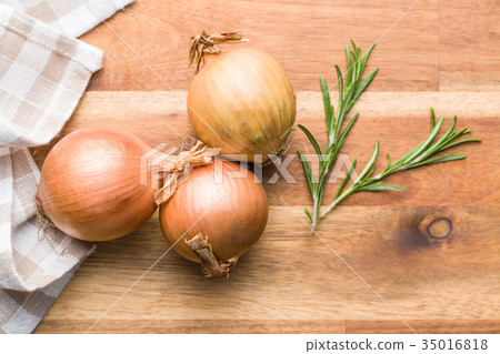Fresh onion bulbs and rosemary branch. 35016818