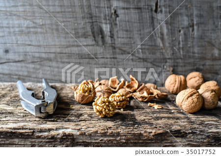 Nuts and nutcrackers on an old wooden tableset 35017752