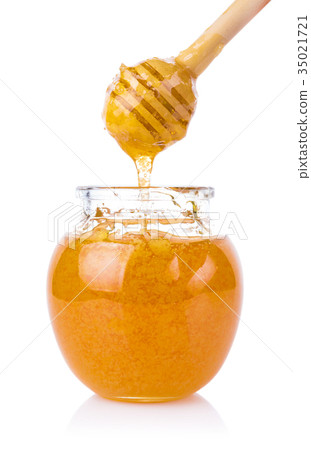 glass jar of honey and stick isolated on white 35021721