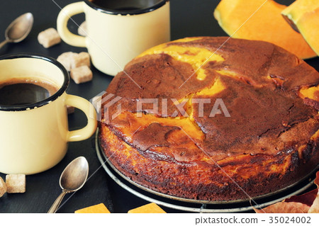 Pumpkin chocolate cake on dark background with 35024002