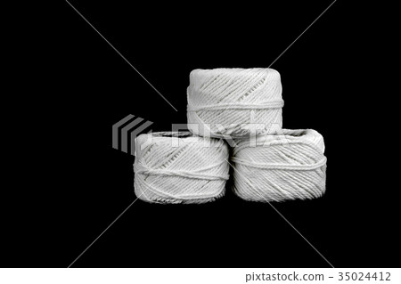 roll of white rope on black background 35024412