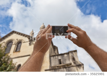 Tourist taking photo of Perigueux, France Tourist taking photo of Perigueux, France 35025991