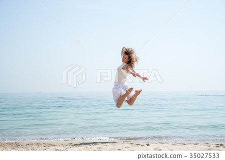 Happy beautiful young girl jumping 35027533