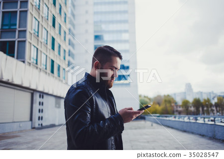 man in the street with phone man in the street with phone 35028547