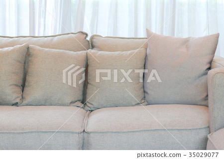 Gray pillows setting on gray sofa in living room Gray pillows setting on gray sofa in living room 35029077