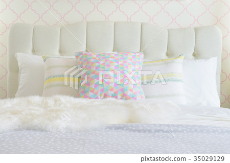 Fur on bed with sweet color pillows in background 35029129