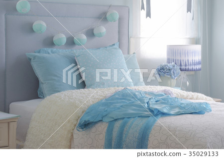 Light blue chiffon dress on beige puffy blanket 35029133