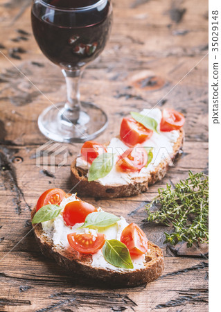 Crostini appetizers with cherry tomatoes, and 35029148