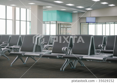 waiting area at airport terminal with empty chairs 35029152
