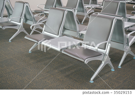 waiting area at airport terminal with empty chairs 35029153