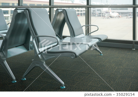 row of gray seats at airport terminal row of gray seats at airport terminal 35029154