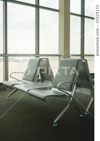 waiting area at airport terminal with empty chairs 35029155