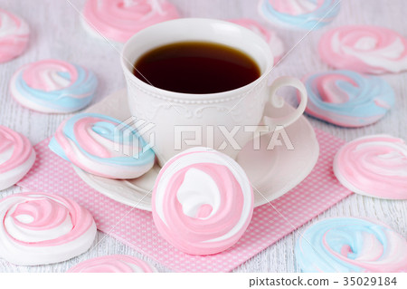 meringues in pastel colors with a cup of coffee 35029184