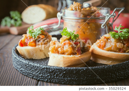 Bread toasts with eggplant caviar. 35029324
