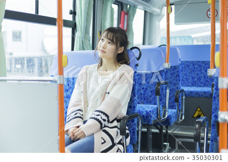 Woman riding a bus Woman riding a bus 35030301