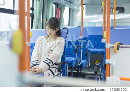 Woman riding a bus Woman riding a bus 35030302