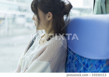Woman riding a bus Woman riding a bus 35030313