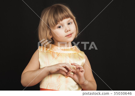 Caucasian blond girl in yellow dress on black Caucasian blond girl in yellow dress on black 35030646