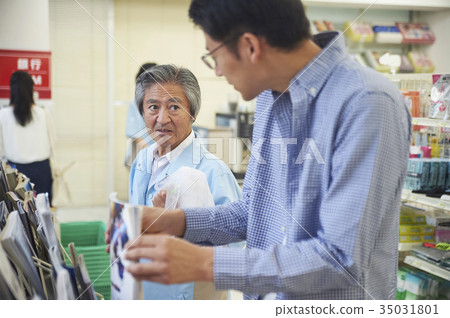 Men reading at a convenience store Men reading at a convenience store 35031801