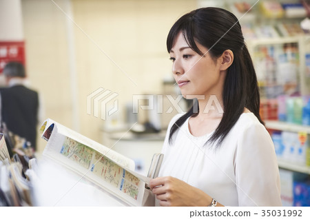 A woman browsing at a convenience store A woman browsing at a convenience store 35031992