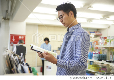 Men reading at a convenience store Men reading at a convenience store 35032193