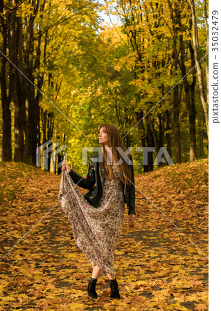 A girl is walking in an autumn park 35032479