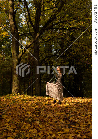 A girl is walking in an autumn forest 35032481
