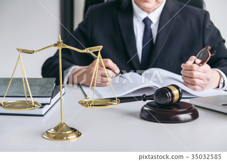 Close up of gavel, Male lawyer or judge working with scales of j Close up of gavel, Male lawyer or judge working with scales of j 35032585