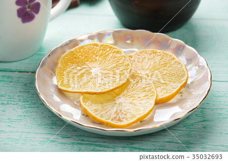 slices of lemon on a saucer slices of lemon on a saucer 35032693