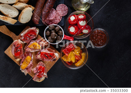 Spanish tapas with slices jamon serrano Spanish tapas with slices jamon serrano 35033300